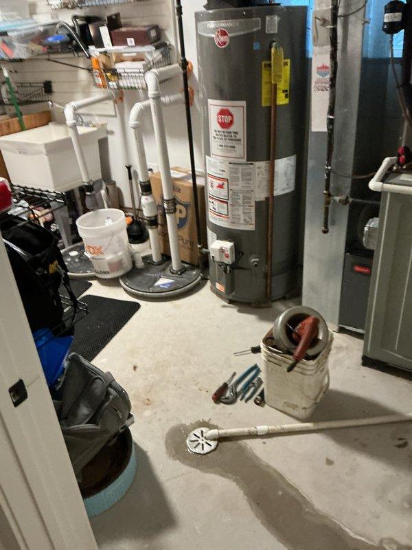 Completed water heater replacement in basement utility area, installing a new Rheem Performance unit with proper PVC venting and copper piping connections. System was tested and verified to be functioning correctly with no leaks observed at connection points.