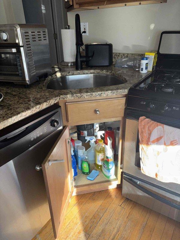 Responded to service call for malfunctioning garbage disposal and sink drainage issue. Inspected single-basin stainless steel sink and under-sink area. Cleared blockage in disposal unit and drain line, restoring proper functionality to both the garbage disposal and kitchen sink drainage system.
