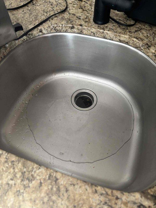 Responded to service call for malfunctioning garbage disposal and sink drainage issue. Inspected single-basin stainless steel sink and under-sink area. Cleared blockage in disposal unit and drain line, restoring proper functionality to both the garbage disposal and kitchen sink drainage system.