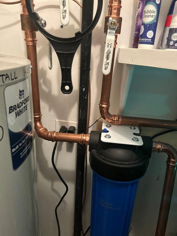 Successfully replaced customer-supplied filter in Aquasana whole house water filtration system. Verified proper installation and confirmed system operation with blue indicator light functioning correctly.