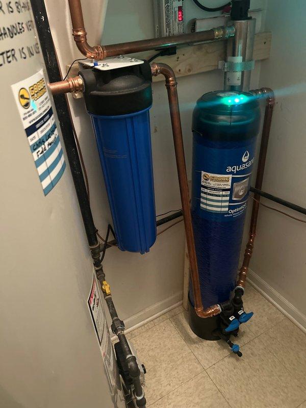 Successfully replaced customer-supplied filter in Aquasana whole house water filtration system. Verified proper installation and confirmed system operation with blue indicator light functioning correctly.