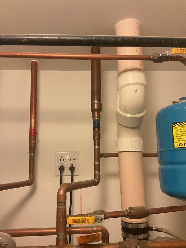 Completed water heater installation for VIP client during afternoon appointment. Installation included drainage system with sump pump and water filtration components. All copper and PVC piping properly fitted with appropriate valves and expansion tank.