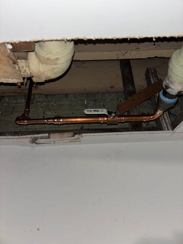 Completed installation of new copper plumbing line with connections to existing PVC supply lines for bathroom shower system. Successfully connected and tested six chrome fixtures including dual shower heads, middle water outlets, and control handles on salmon-colored bathroom wall as part of previously sold repair job. Parts were installed as ordered per original service agreement.