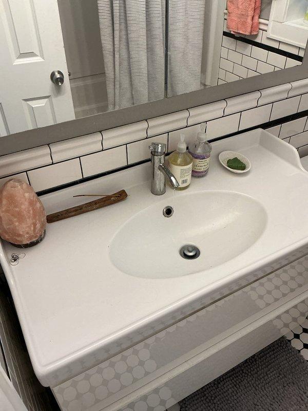 Responded to service call for a 10-year-old tankless water heater with no hot water in one unit. Diagnosed low water pressure issue affecting only this unit within multi-unit building. Previous water heater replacement in parkway area appears to have impacted pressure to this specific unit. Visual inspection of bathroom fixtures confirmed pressure problem.