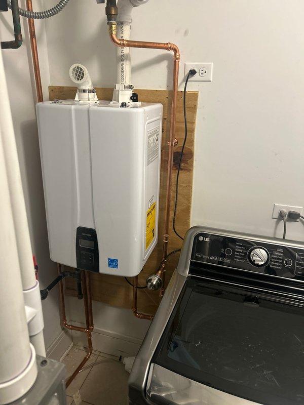 Successfully installed a new tankless water heater in client's utility area, mounting the unit securely on a wooden backing board. Completed all necessary copper pipe connections with proper fittings and valves, and ensured the system was fully operational with no leaks upon final inspection.