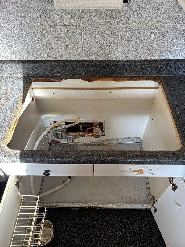 Completed installation of new drop-in sink faucet as requested by customer. Reconfigured existing PVC and copper waterlines to accommodate the new fixture, addressing visible water damage along countertop edge. All connections tested for proper function and leaks.