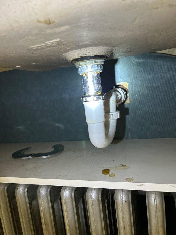 Investigated low water pressure issue at kitchen sink. Discovered significant pipe corrosion causing internal blockage, evidenced by metal shavings in drain line. Identified water damage on ceiling below, indicating possible leak in drainage system. Replaced corroded section of supply line and installed new P-trap assembly to restore proper water flow and prevent further deterioration.