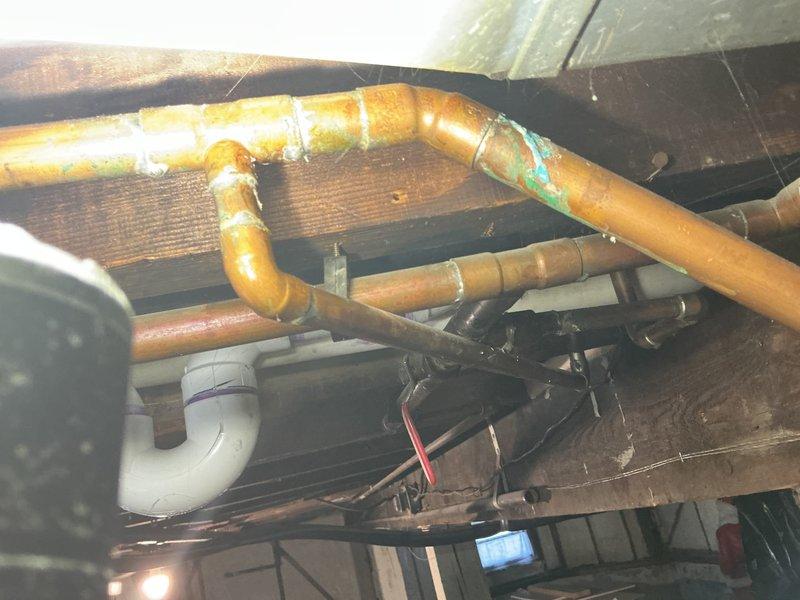 Conducted assessment for small kitchen remodel project involving sink and stove relocation. Inspected existing plumbing infrastructure including copper supply lines showing significant oxidation/corrosion at joints and drainage system with PVC components. Evaluated basement utility area with floor drain installation to determine necessary modifications for fixture repositioning.