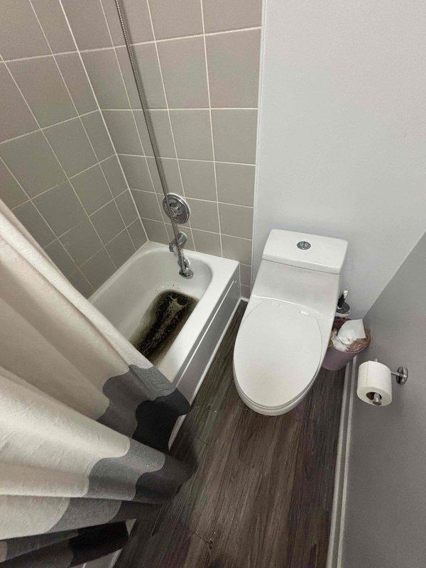 Responded to service call for clogged bathtub drain with sewage backup. Upon inspection, identified significant blockage in the main drain line causing wastewater to back up through the tub drain. Successfully cleared the obstruction using drain snake and hydro-jetting equipment, restoring proper drainage function and eliminating backup issue.