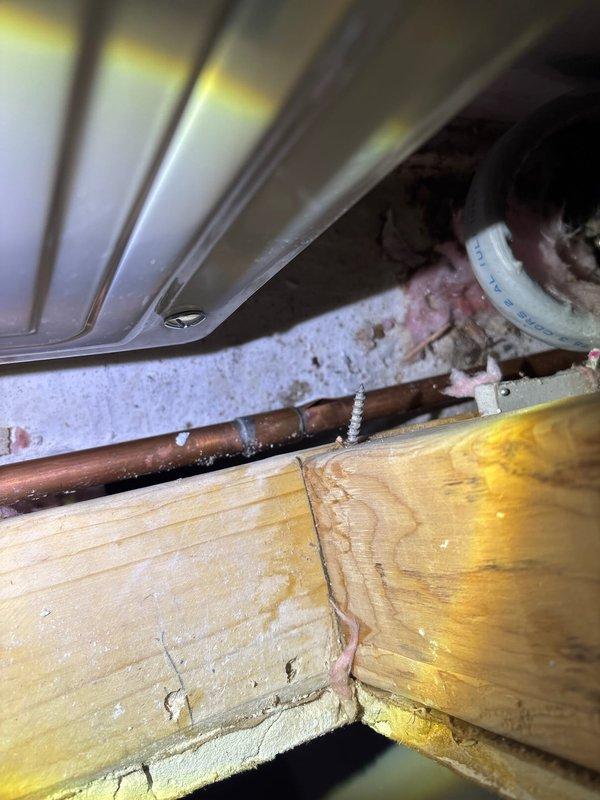 Responded to emergency call for a burst pipe in customer's basement. Upon inspection, discovered a frozen copper pipe that had ruptured, causing water damage to surrounding wooden joists. Cut access hole in wall to reach affected area, replaced damaged section with new copper pipe and PVC fitting, and restored water service to the home.
