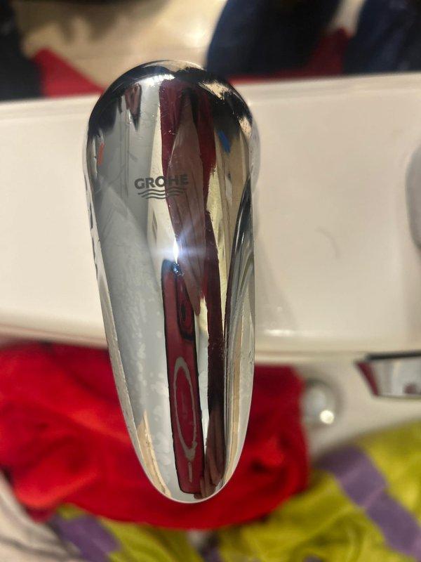 Completed installation of GROHE bathroom fixture at customer's sink. Replaced damaged valve components and verified proper water flow. All connections tested for leaks and system functioning correctly.