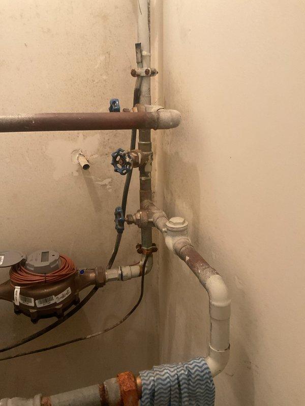 Conducted comprehensive inspection of aging booster pump system showing significant rust deterioration at the base and connection points. Examined the blue cylindrical pressure tank, associated copper/PVC piping network, and control valves for overall condition assessment. Provided customer with replacement options for the deteriorating pump assembly.