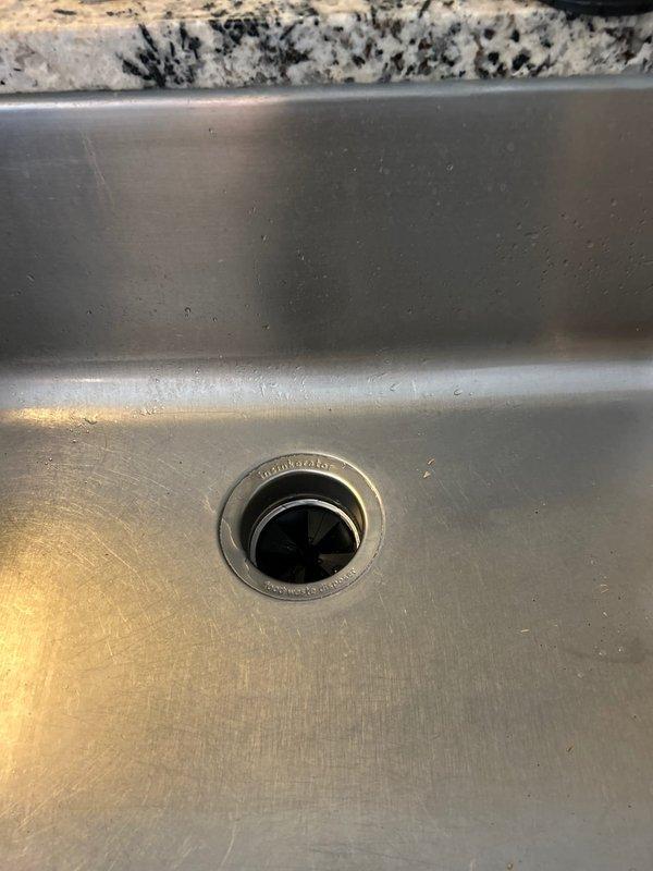 Responded to priority service call regarding leaking garbage disposal unit. Upon inspection, found significant water damage and rust on cabinet floor with deterioration to cabinet ceiling. Replaced faulty disposal unit, ensuring proper connection to existing PVC P-trap assembly and electrical conduit. Verified proper operation and confirmed no leaks after installation.