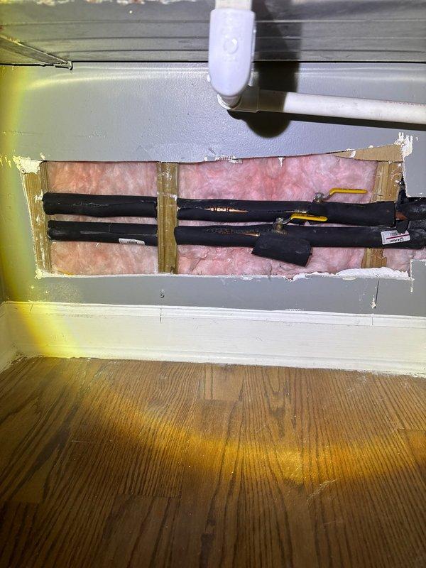 Responded to frozen pipe emergency. Opened wall section to access affected copper supply lines, which showed signs of freezing and condensation. Applied controlled heat to thaw pipes and installed additional insulation around exposed plumbing to prevent future freezing issues.
