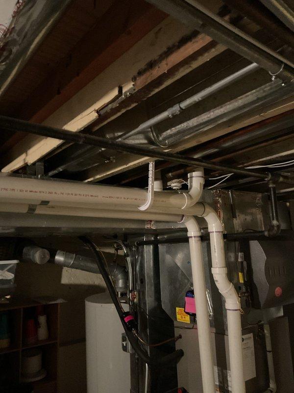 Responded to service call for a clogged kitchen sink with slow drainage issues. Upon inspection, discovered significant buildup in the drainage pipes in basement area, particularly at connection points between PVC sections and flexible corrugated hose where deterioration and mineral deposits were evident. Successfully cleared blockage and restored normal drainage function.
