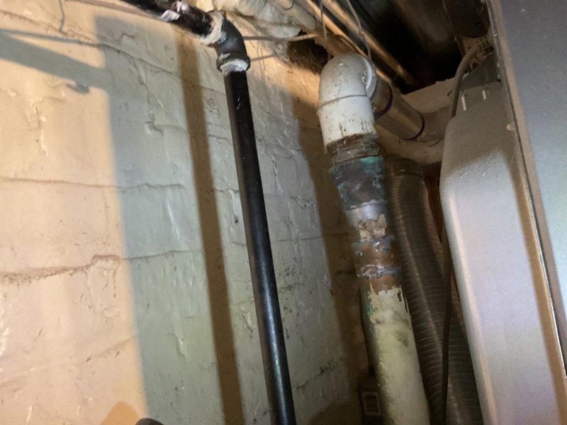 Responded to service call for a clogged kitchen sink with slow drainage issues. Upon inspection, discovered significant buildup in the drainage pipes in basement area, particularly at connection points between PVC sections and flexible corrugated hose where deterioration and mineral deposits were evident. Successfully cleared blockage and restored normal drainage function.