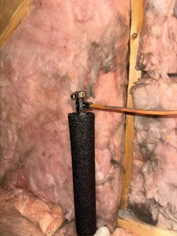 Completed angle stop installation as requested, including application of 1/2" pipe insulation to protect plumbing components. Installation involved connecting copper and PVC lines to the new angle stop valve, with proper insulation secured between wall studs to ensure compliance with building standards.
