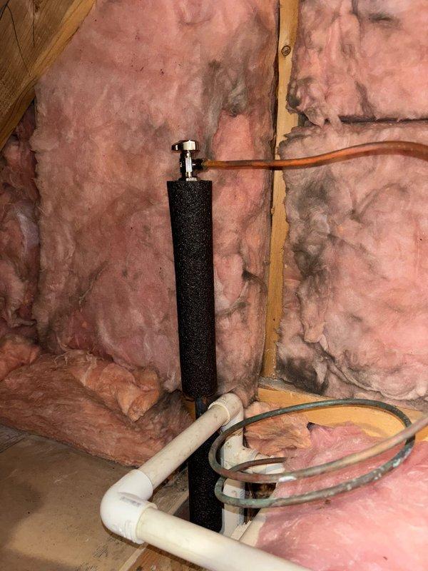 Completed angle stop installation as requested, including application of 1/2" pipe insulation to protect plumbing components. Installation involved connecting copper and PVC lines to the new angle stop valve, with proper insulation secured between wall studs to ensure compliance with building standards.