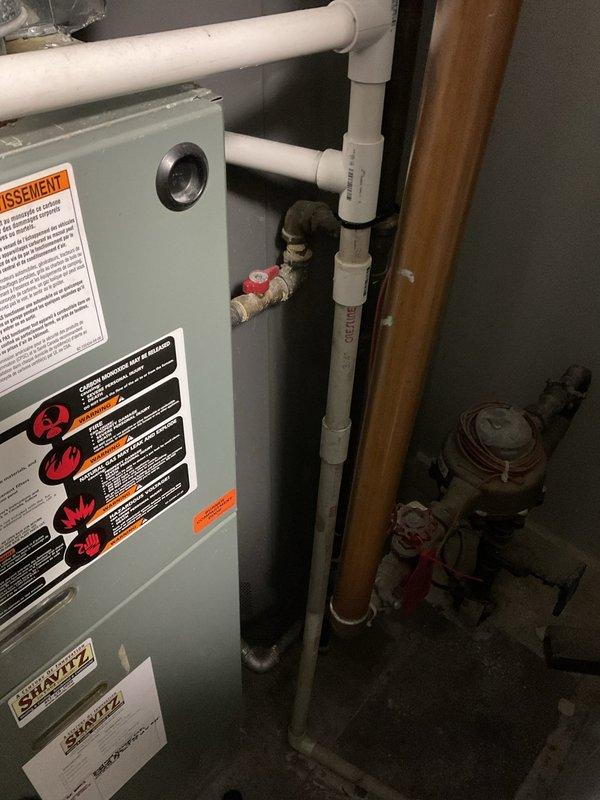 Completed repair of HVAC system sold by Jon, which included inspection and service of the furnace unit and associated copper/PVC piping network in the mechanical room. Documented the installation with photos showing the main furnace cabinet with safety warning labels, connecting ventilation pipes, water heater, and the comprehensive copper piping system that integrates with PVC sections through the ceiling.