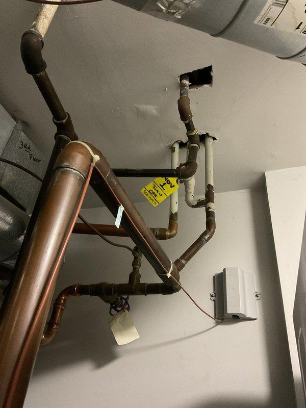 Completed repair of HVAC system sold by Jon, which included inspection and service of the furnace unit and associated copper/PVC piping network in the mechanical room. Documented the installation with photos showing the main furnace cabinet with safety warning labels, connecting ventilation pipes, water heater, and the comprehensive copper piping system that integrates with PVC sections through the ceiling.