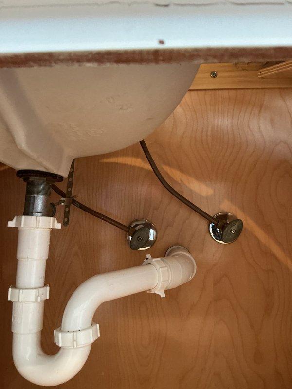 Responded to service call for a bathroom sink with reported gap between sink and vanity due to seal issue. Upon inspection, examined the P-trap assembly, water supply lines, and mounting bracket securing the plumbing components. Verified proper connection of drain pipe to wall and checked compression fittings throughout the system. Completed repair by resealing sink-to-vanity connection, ensuring proper alignment and watertight seal.