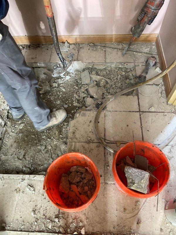 Completed installation of new water supply valves with access box in concrete floor. Demolished existing tile and concrete to properly set recessed valve box with dual shut-off controls. Installation included proper framing support and connection to existing wall-mounted supply lines.