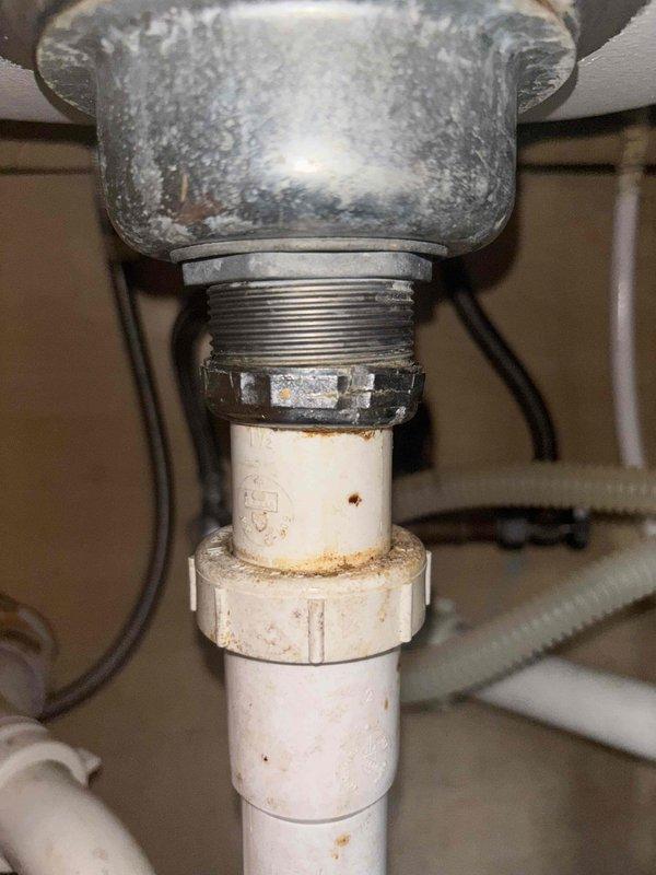 Replaced non-functioning garbage disposal unit in kitchen sink. Removed corroded metal connections and installed new unit with proper PVC drain piping. Tested system for proper operation and verified no leaks at connection points.