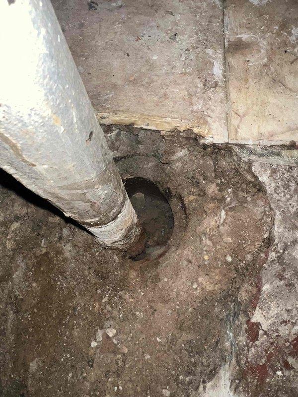 Excavated floor to access damaged underground pipe showing signs of corrosion and deterioration. Work area was properly prepared with necessary tools for the repair operation. Client made partial payment via check, with excavation scheduled for completion tomorrow at noon as confirmed with Julio.