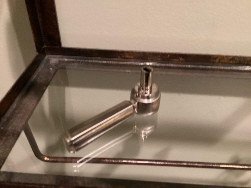 Responded to service call for toilet fixture maintenance. Replaced worn flush valve actuator mechanism and serviced electronic sensor control panel on wall-mounted urinal/toilet. Cleaned water residue from sensor panel and verified proper flush operation after installation.
