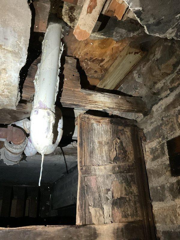 Performed inspection of basement plumbing system and identified damaged PVC drainage pipe with visible insulation protrusion. Replaced deteriorated section of sink drain line and addressed water leak affecting building sink. Repaired connection between older metallic plumbing components and PVC pipes, ensuring proper sealing at junction points to prevent future leakage.