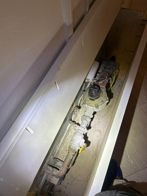 Responded to emergency call for frozen pipe concerns. Upon inspection of the utility access area, examined gas valve assembly and associated piping which showed signs of age and wear. Inspected gas meter/regulator valve assembly with connected copper tubing for proper function and integrity. No active leaks detected; system now operating within normal parameters.