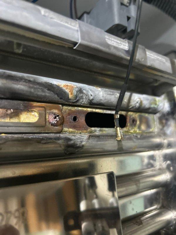 Inspected customer's plumbing system regarding persistent low water pressure complaint. Discovered significant corrosion and oxidation on metal components of the water supply assembly. Removed and examined damaged pressure regulator components showing ceramic insulators with corroded terminals and connection points. Further investigation required to fully resolve the ongoing pressure issues.