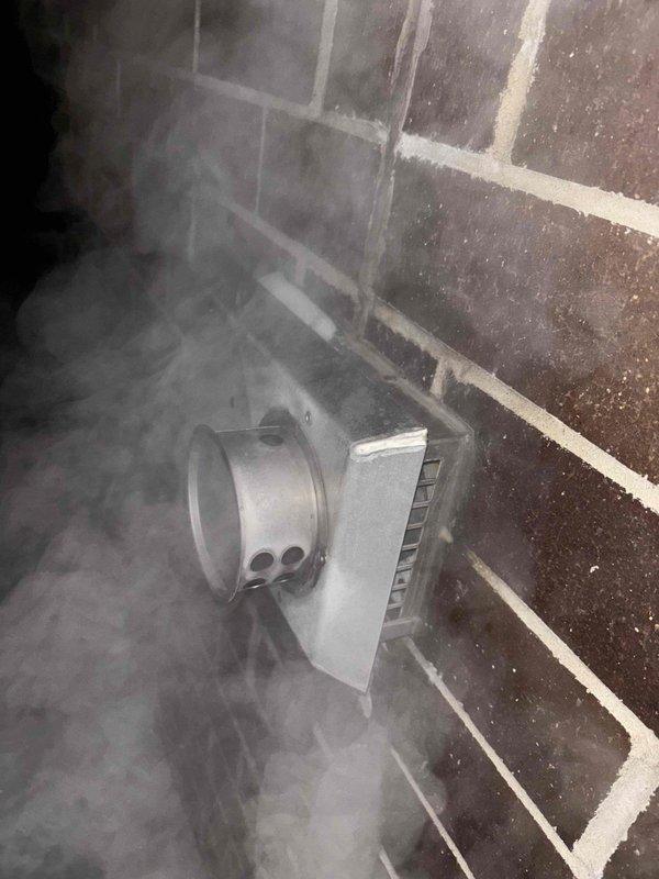 Responded to warranty call for recently installed water heater displaying error code 271 and producing only warm water. Diagnosed issue with Navien unit showing visible vapor/smoke emission from wall-mounted vent. Inspected copper and PVC piping connections in basement utility area, focusing on potential issues at joints where different materials meet.