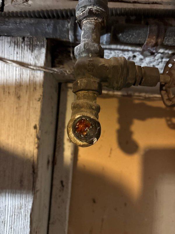 Replaced corroded brass pressure regulator valve that showed significant internal buildup and mineral deposits. Removed existing fixture from water supply line and installed new component to restore proper water pressure regulation and prevent potential leakage issues.