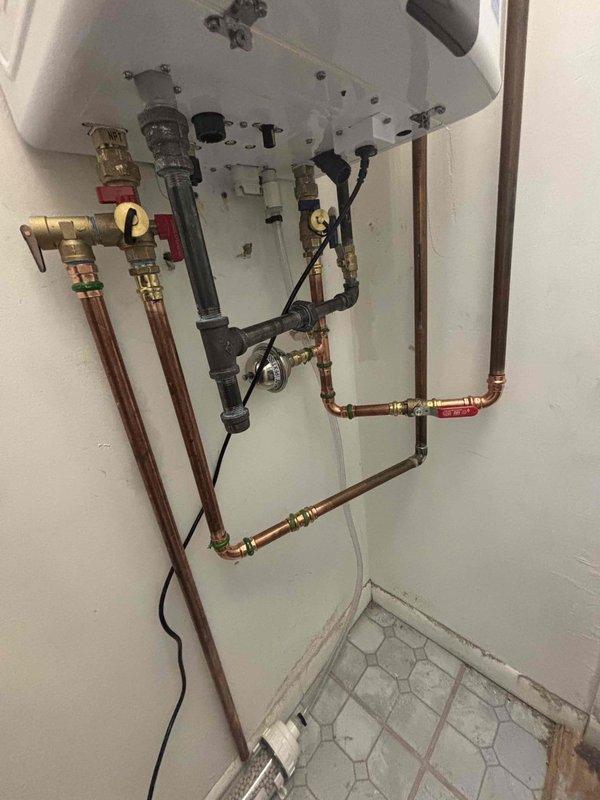 Successfully completed installation of a new tankless water heater system, replacing the previous tank-style unit. Work included configuring copper supply lines, installing necessary valves and fittings, and ensuring proper connection of pressure relief valve. All components were tested and verified to be functioning correctly.
