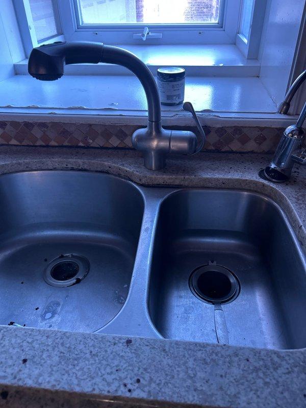 Inspected property for sump pump installation requirements. Evaluated existing kitchen sink plumbing system, noting functional garbage disposal unit with proper drainage connections. Customer not present during assessment; accessed property using provided door code (2377). Will return to complete installation when black shower valve arrives, with follow-up call to confirm customer availability.