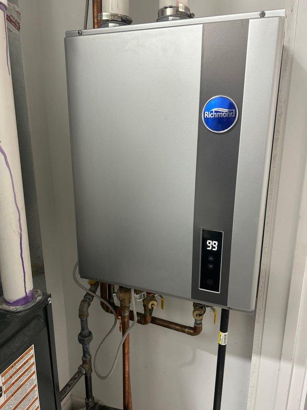 Responded to service call for Richmond tankless water heater displaying error code 99 with no hot water output. Diagnosed issue with the unit's ignition system and performed complete maintenance service including descaling of heat exchanger and cleaning of inlet filter. System now functioning properly with normal temperature readings and consistent hot water delivery.