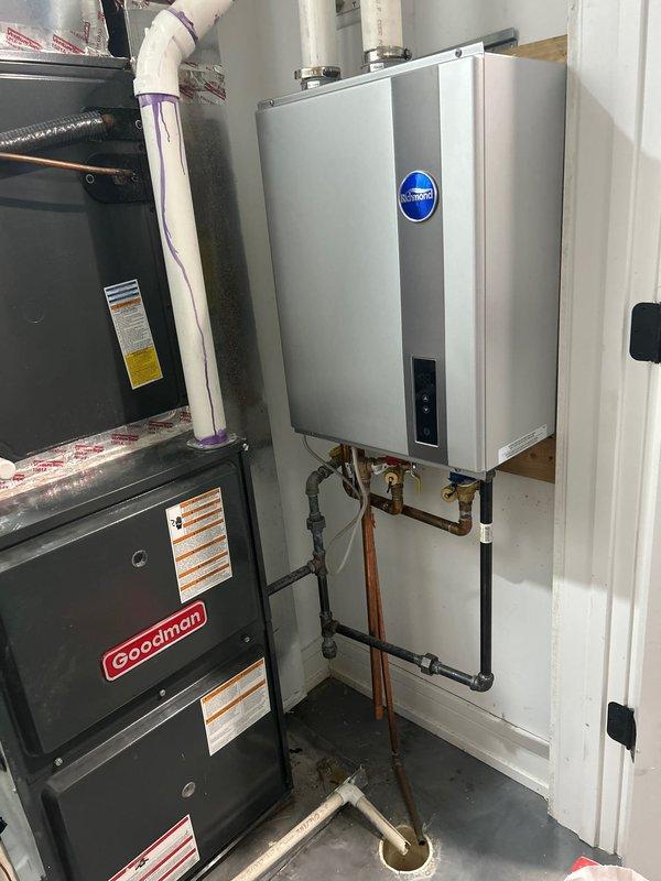 Responded to service call for Richmond tankless water heater displaying error code 99 with no hot water output. Diagnosed issue with the unit's ignition system and performed complete maintenance service including descaling of heat exchanger and cleaning of inlet filter. System now functioning properly with normal temperature readings and consistent hot water delivery.