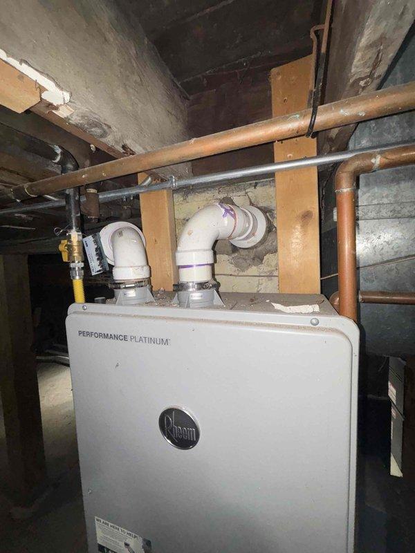 Responded to priority water leak service call. Upon inspection, discovered corroded copper pipes behind wall requiring access cutout. Replaced damaged section of piping with new copper fittings near the Rheem Performance Platinum water heater installation, restoring proper function and preventing further water damage.