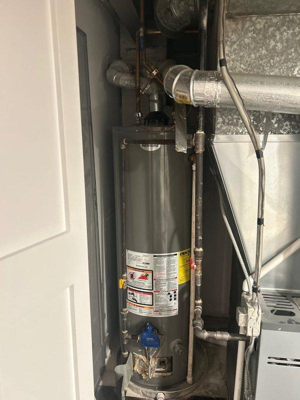 Responded to service call for a tank water heater (6+ years old) with extinguished pilot light. Upon inspection, reignited pilot light and verified proper operation. Performed safety check of all connections, valves, and ventilation components. Noted standard installation with appropriate drainage system and plumbing connections intact.