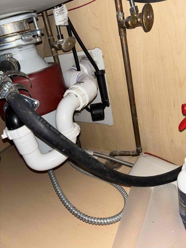 Responded to service call for multiple kitchen sink drainage issues in three-unit condo building. Diagnosed severe main line blockage causing backflow into dishwasher and sink drains. Cleared obstruction using professional-grade drain cleaning equipment, restored proper drainage to all affected units, and verified system functionality by testing all connected fixtures.