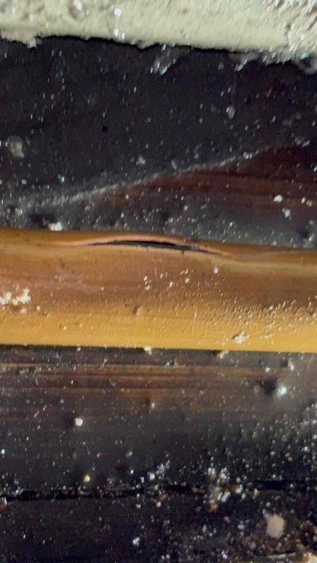 Responded to emergency water leak call where water was penetrating through ceiling light fixtures. Inspection revealed structural damage with a cracked wooden beam in the building framework, likely the source of the leak. Repaired damaged section and verified no additional water intrusion to surrounding areas including carpeted rooms with window installations.