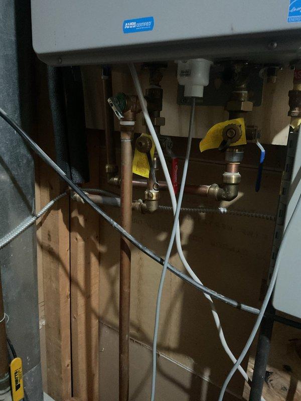 Diagnosed tankless water heater displaying error code 180. Inspected gas supply, water connections, and ventilation system. Cleaned scale buildup from heat exchanger and flushed system to restore proper operation. Unit now producing consistent hot water with normal temperature regulation.
