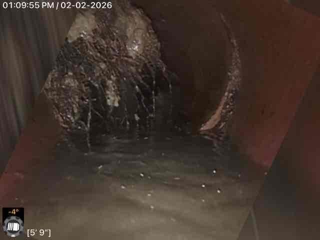 Performed callback service for Jon. Conducted inspection of drainage system using camera equipment, documenting significant debris accumulation and standing water. Inspection revealed fibrous material buildup at 16'2" and moisture/water accumulation with possible mineral deposits at 5'9" within the pipe system.