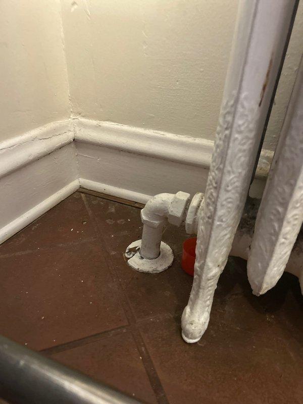 Replaced defective radiator valve with new 3/4" valve on vintage cast iron radiator. System was restored to proper functionality with no leaks observed during testing.