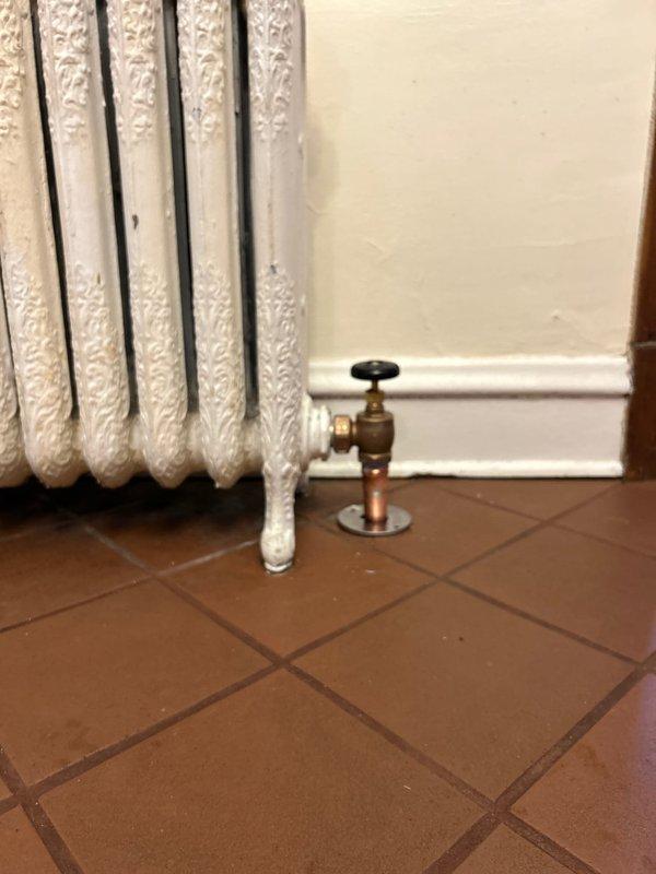 Replaced defective radiator valve with new 3/4" valve on vintage cast iron radiator. System was restored to proper functionality with no leaks observed during testing.