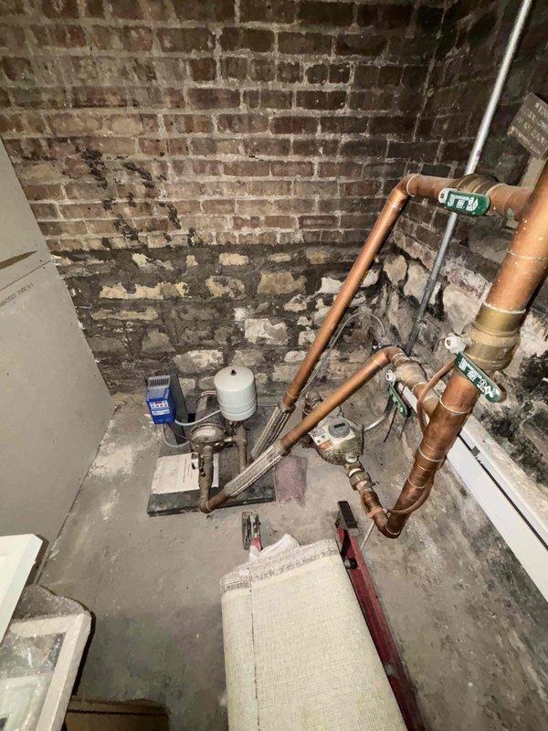Cleared severe clog from bathroom drain that was causing slow drainage. Inspected water heater system in basement utility area, noting copper supply lines, expansion tank, and drain piping configuration. Provided verbal recommendations for water heater maintenance and exterior cleanout rodding services.