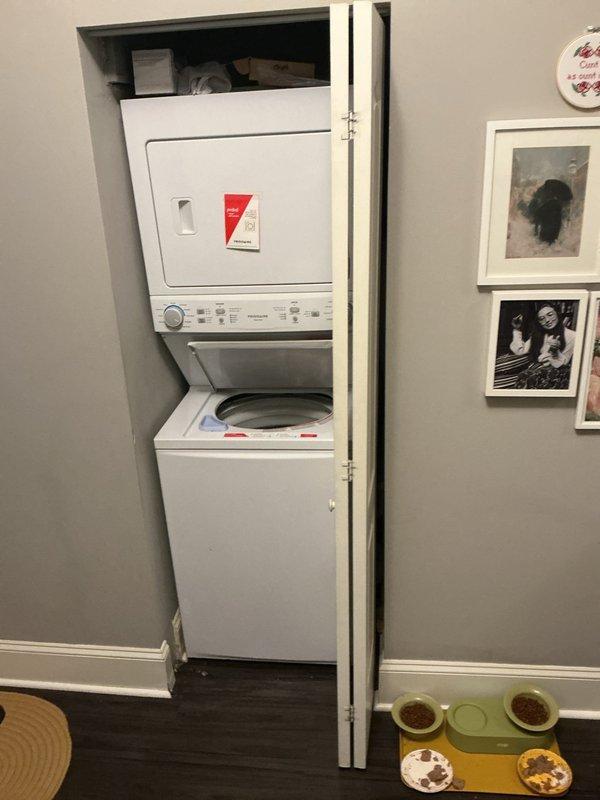 Responded to a callback service request for a laundry drain obstruction that could not be cleared during previous visit. Inspected the stacked washer/dryer installation and associated PVC drain system. Located blockage in the main vertical waste line where blue marker lines were visible. Successfully cleared the obstruction and verified proper drainage. Water marks on floor near drain connection were cleaned and system was tested to ensure full functionality.