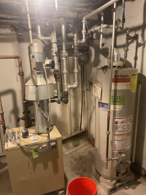 Conducted callback inspection of residential mechanical room. Assessed plumbing configuration including copper and galvanized steel pipe network, multiple valves, and pipe fittings. Evaluated A.O. Smith water heater and furnace system for proper operation and connection integrity.