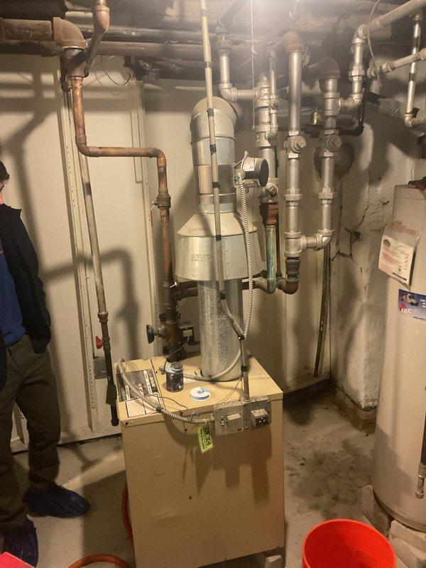 Conducted callback inspection of residential mechanical room. Assessed plumbing configuration including copper and galvanized steel pipe network, multiple valves, and pipe fittings. Evaluated A.O. Smith water heater and furnace system for proper operation and connection integrity.